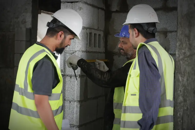 Two contractors reviewing work on site